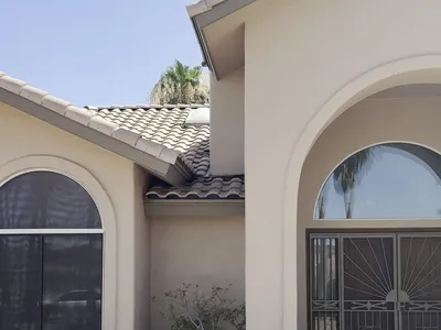 Arched entry of Fountain Hills AZ home during prep with masking and after finished exterior repaint