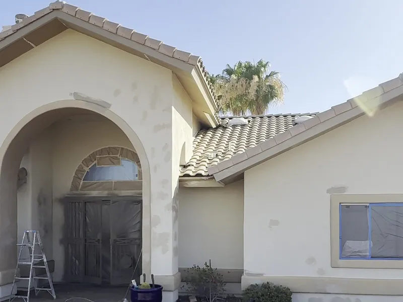 Arched entry of Fountain Hills AZ home during prep with masking and after finished exterior repaint